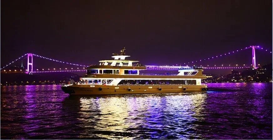 A dinner cruise boat lit up at night on the Bosphorus
