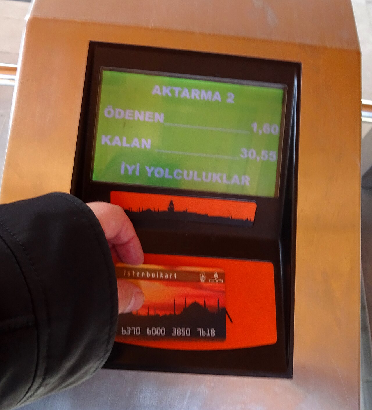 Orange Istanbulkart terminal displaying the fare charged and the remaining card balance