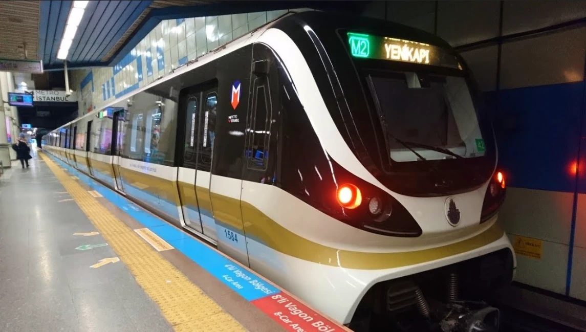 An M2 metro train at a platform with Yenikapi on its destination display