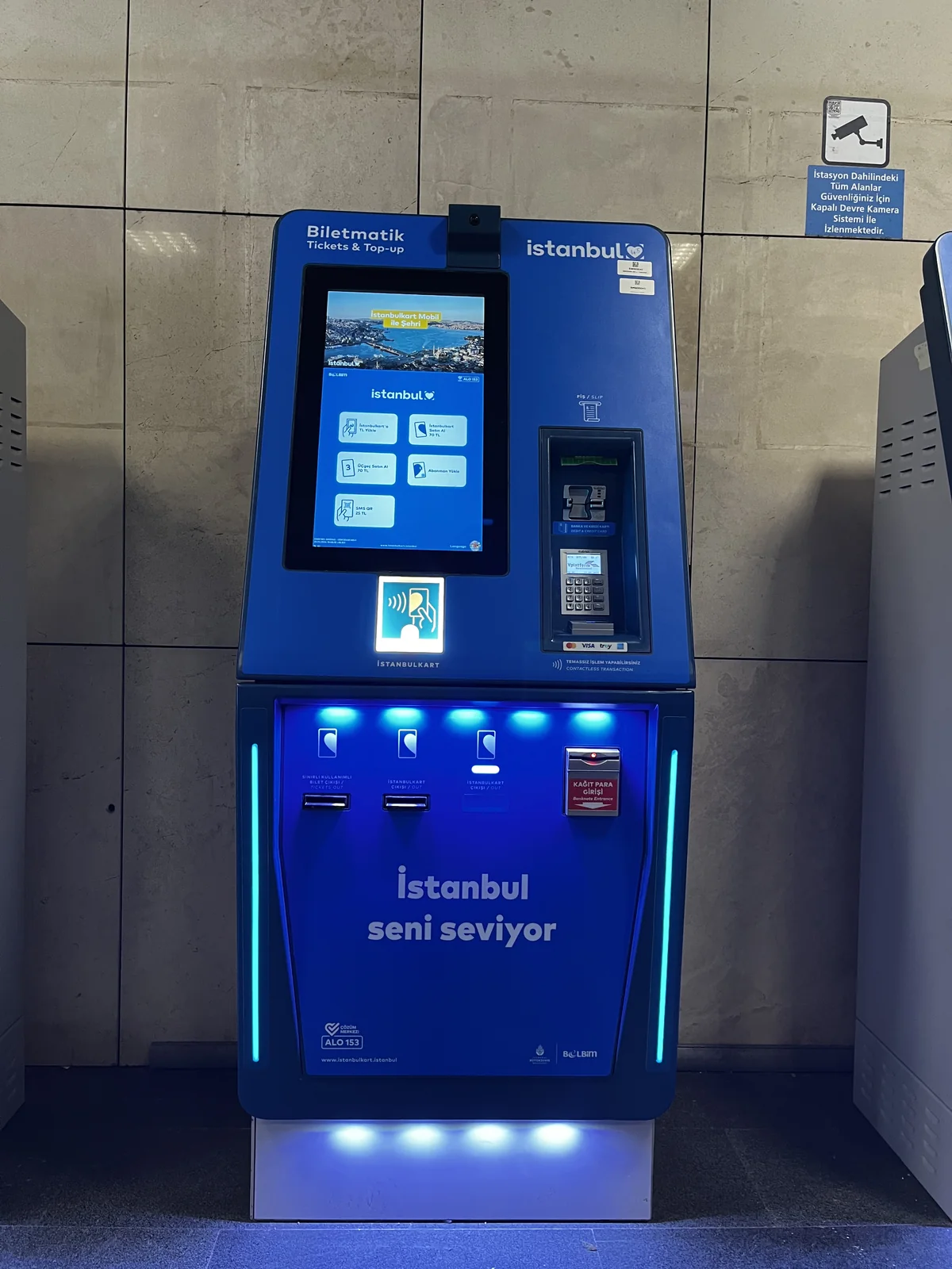 Blue Istanbulkart ticket machine with a touchscreen, transport-card area and separate payment terminal