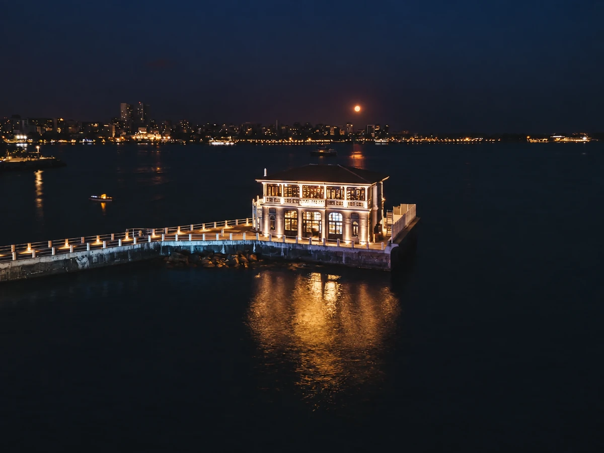 Moda Pier illuminated beside the water after dark