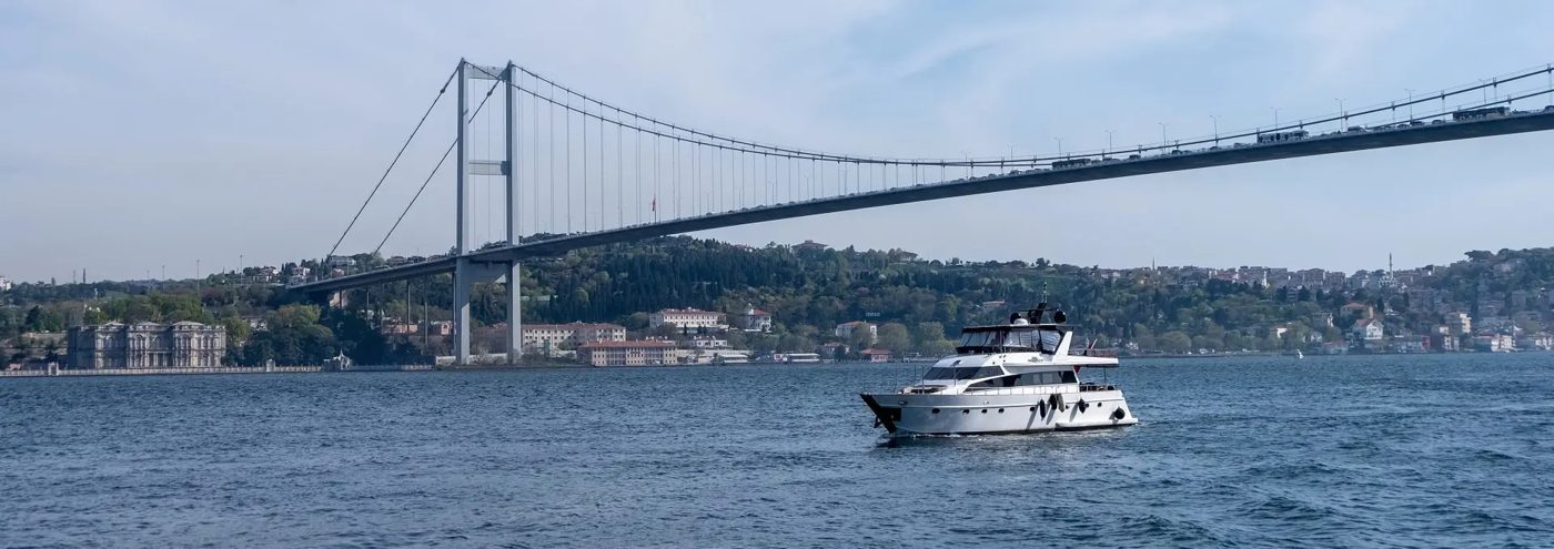 Private yacht under the Bosphorus Bridge
