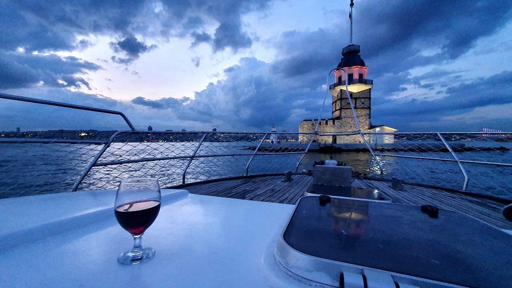 Glass of wine on deck with the Maiden’s Tower behind