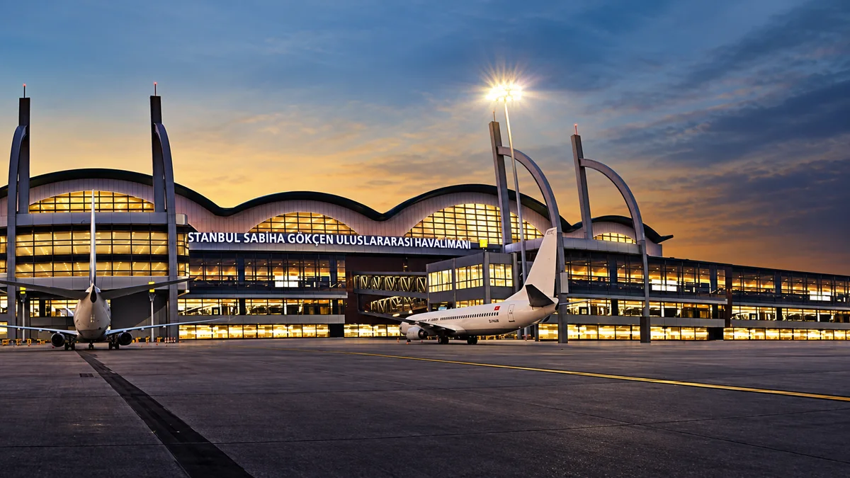 Sabiha Gökçen Airport terminal exterior at dusk with aircraft on the apron