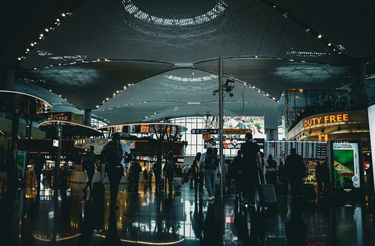 Travellers with luggage inside Istanbul Airport terminal