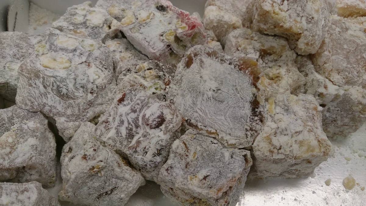 Cut Turkish delight pieces with visible nuts and sugar dusting