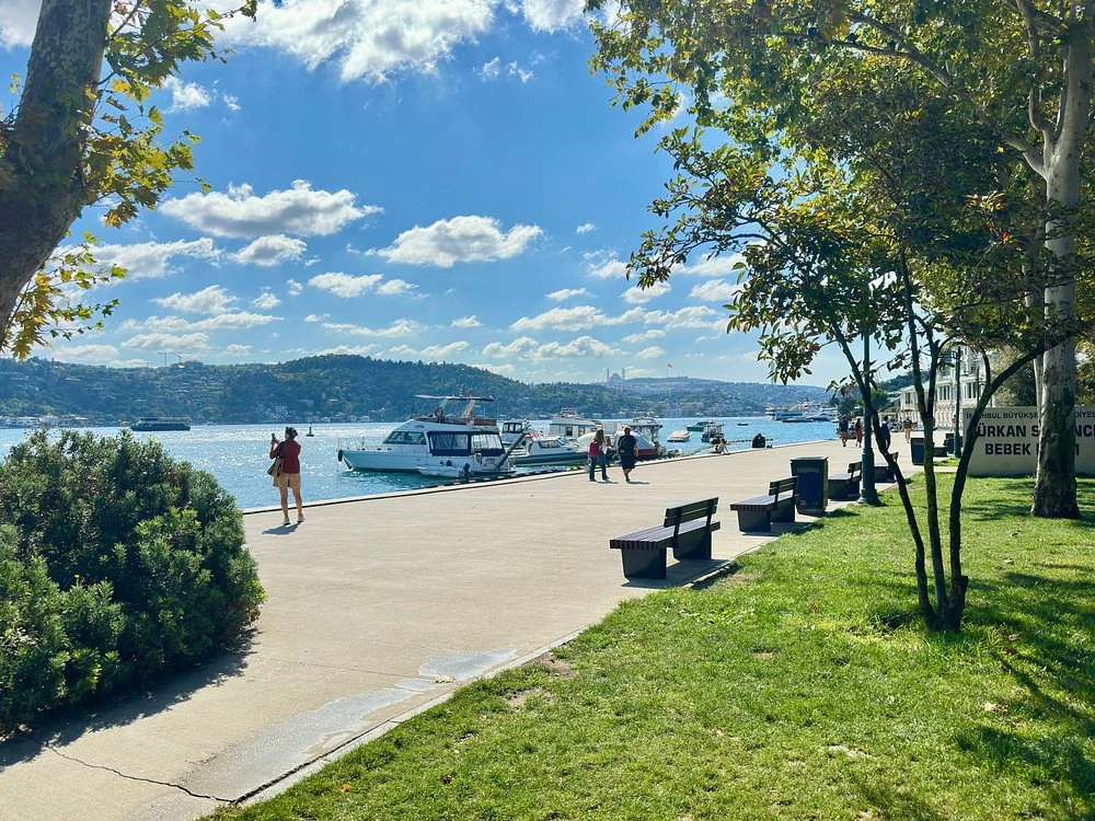Bebek Park waterfront promenade with benches, trees and boats on the Bosphorus