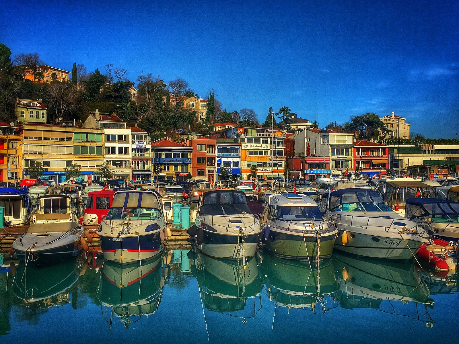 Fishing boats and colourful waterfront buildings around Tarabya Bay